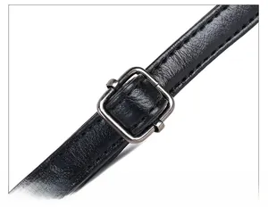 Detail of adjustable silver buckle and premium black leather texture on shoulder strap