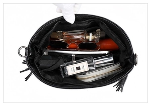 Top view of spacious black pebbled leather handbag showing interior compartments and pockets