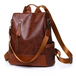 Detail of dark brown textured PU leather backpack with vertical zipper and side pocket