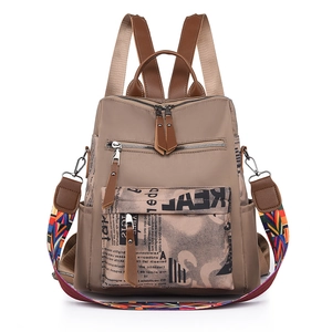 Women oxford backpack with newspaper print design and colorful woven shoulder strap