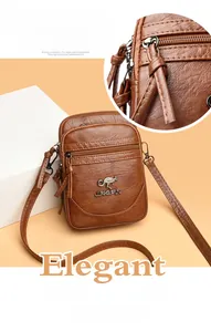 Detailed view of brown lychee texture leather crossbody bag with multiple zippers