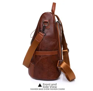Side view detail of a vintage brown PU leather backpack with pebbled texture and metal hardware