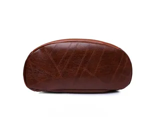 Detailed bottom view of dark brown pebbled leather backpack with geometric stitching