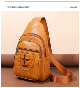 Close-up of ginger yellow sling bag with lychee grain texture and woven cord detail