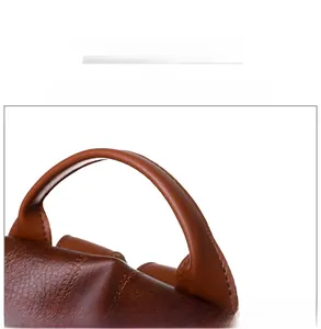 Detailed close-up of the reinforced brown leather handle with premium stitching