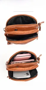Detail view of multi-layer zipper compartments in brown PU leather crossbody bag