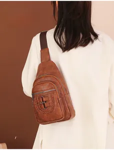 Rear view of vintage brown PU leather sling bag with woven strap and metal buckle detail