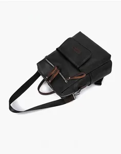 Close-up of black lychee grain leather backpack with magnetic flap pocket and metal zipper