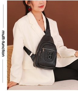Detail of black pebbled leather chest bag with woven texture and multi-zipper pockets