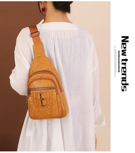Close-up of vintage brown PU leather chest bag with woven texture and multi-pocket design