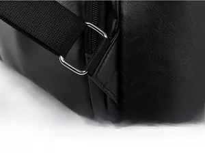 Detail of reinforced triangular stitching and metal buckle on the black PU leather backpack