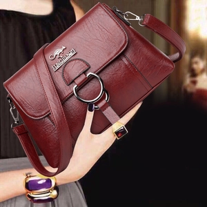 Burgundy PU leather crossbody bag with kangaroo logo and large metal ring buckle