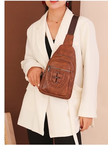 Brown PU leather chest bag detail showing woven loop buckle and textured zippers