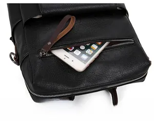 Detail of soft black lychee texture PU leather backpack with a front zipper storage pocket