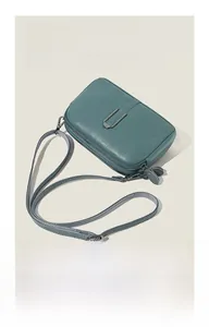 Macro view of cyan pebble grain leather texture with silver U-shaped metal hardware details
