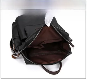 Detail view of large capacity black PU leather backpack showing inner zip pocket and storage