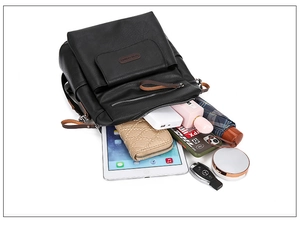 Internal view of black leather backpack showing large storage capacity and compartments