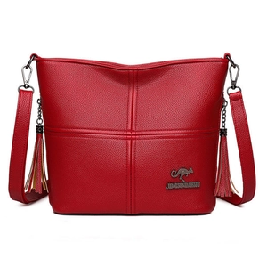Red pebbled leather crossbody bag with twin tassels and golden kangaroo logo accent
