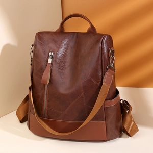 Brown textured faux leather backpack for women with geometric patchwork and anti-theft design