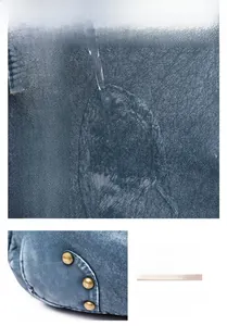 Detail of blue washed leather texture with retro rivets and waterproof surface