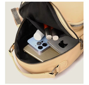 Spacious interior of beige lychee leather backpack with rhinestones and silver zipper