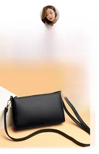 Detail of silver interlocking logo on black lychee grain leather crossbody bag