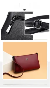 Close-up of metal zipper, adjustable strap buckle and red litchi grain leather texture