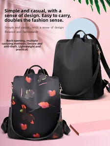 Detail view of anti-theft back zipper opening on oxford floral print and black backpack