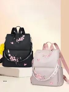 Detailed embroidery of cherry blossoms and butterflies on durable nylon backpack fabric