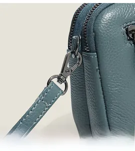Detailed macro view of litchi texture blue leather and premium dark metal hardware