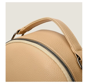 Detailed close-up of textured lychee grain PU leather handle and stitching on the handbag