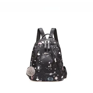 Détail du sac à dos Oxford imprimé galaxie avec fermeture argentée et pompon gris pelucheux