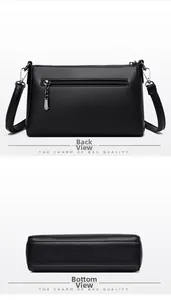 Detail view showing black litchi texture leather bag back zip pocket and wide flat bottom