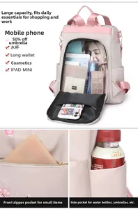 Detail view of pink nylon backpack featuring floral embroidery and multi-pocket storage