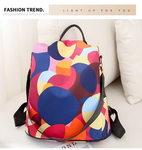 Detail of colorful geometric pattern backpack with gold hardware and top handle strap