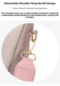 Detail of detachable gold hardware hook and pink faux leather trim on nylon backpack
