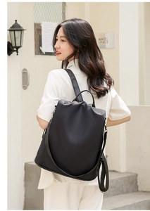 Detail of waterproof black nylon backpack showing anti-theft back zipper and straps