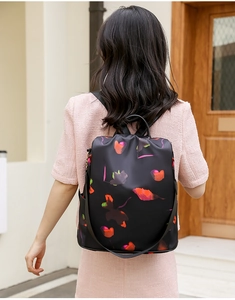Close-up of colorful heart print oxford backpack with anti-theft zipper on stylish woman