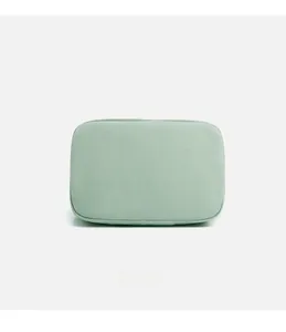 Detailed macro view of mint green canvas fabric and stitching on a minimalist bag