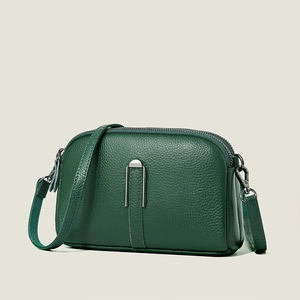 Deep green leather crossbody bag with lychee texture and silver U-shaped buckle