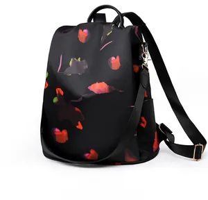 Detail view of floral print oxford backpack with metal carabiner and side pocket