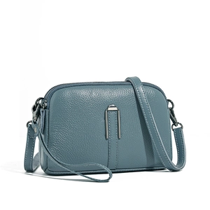 Minimalist fog blue genuine leather crossbody bag with lychee grain texture and metal buckle