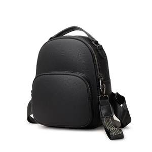 Minimalist black PU leather backpack with lychee texture and metallic stud details
