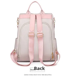 Back view of waterproof nylon backpack with pink leather straps and anti-theft zip pocket