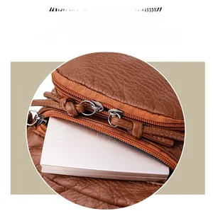 Close-up of brown litchi pattern PU leather with multi-layer zipper storage pockets