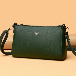 Deep green lychee textured leather crossbody bag with square silver metal logo