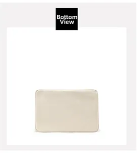 Detail view of the flat reinforced bottom of a spacious canvas tote bag in beige