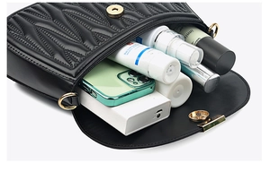 Detail shot of the black quilted leather bag interior showcasing large storage capacity