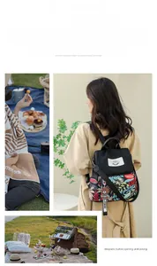 Detail of printed travel backpack with magnetic buckle and cute bear pendant charm