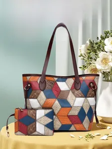 Detail of multi-texture leather tote bag with geometric patchwork and matching pouch
